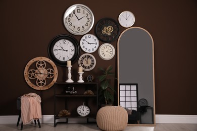 Stylish room interior with collection of wall clocks