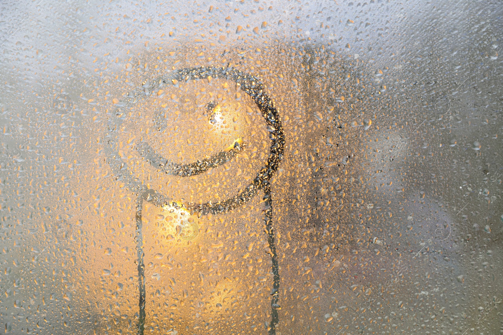 Photo of Happy face drawn on foggy window, space for text. Rainy weather