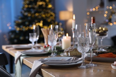 Christmas table setting with festive decor and dishware indoors