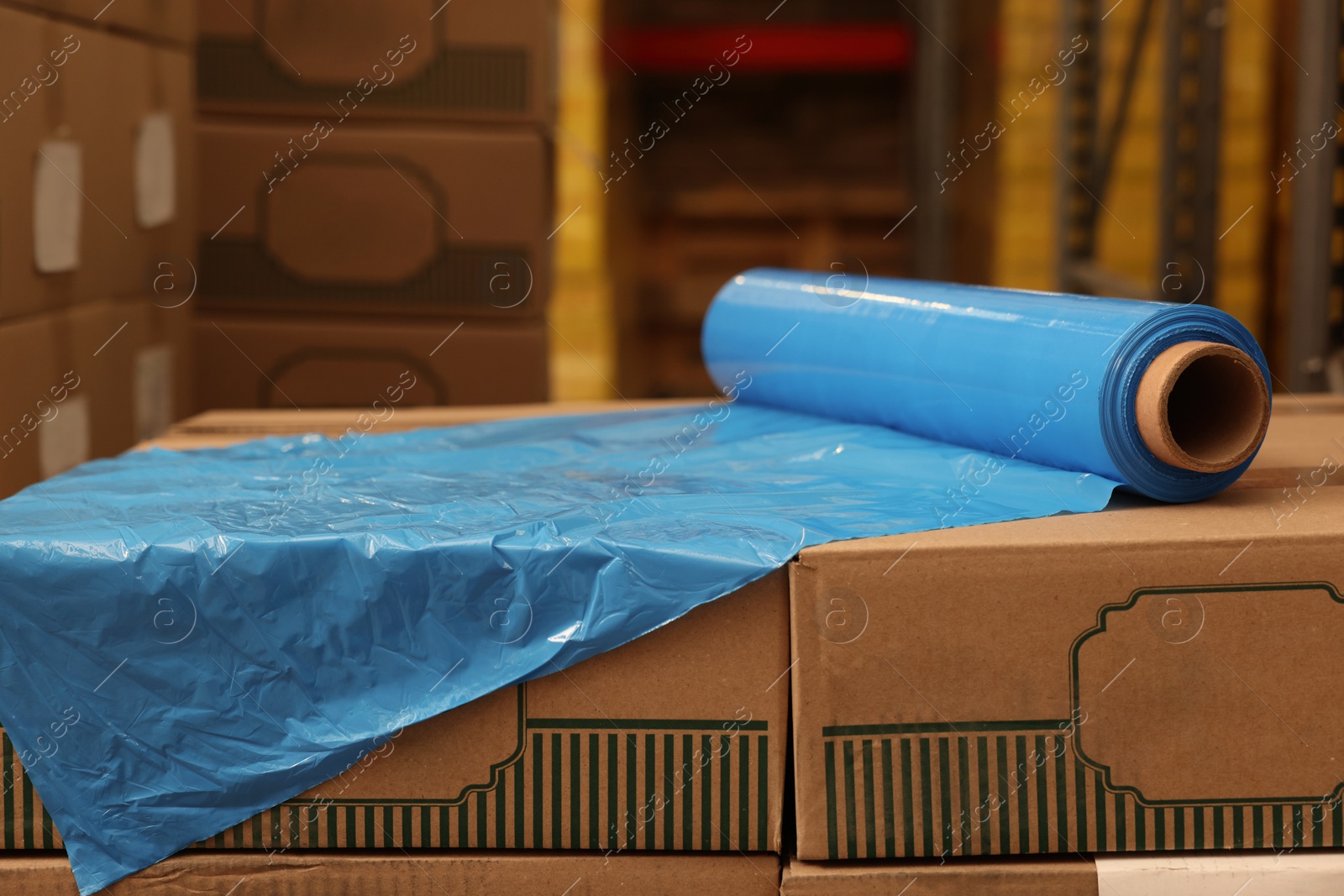 Photo of Roll of stretch wrap on boxes in warehouse