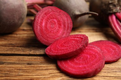 Cut raw beet on wooden table, closeup