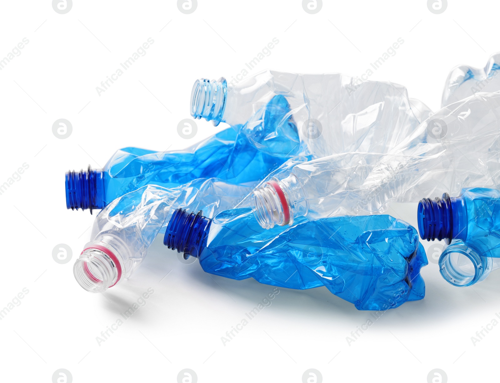 Photo of Crumpled disposable plastic bottles on white background