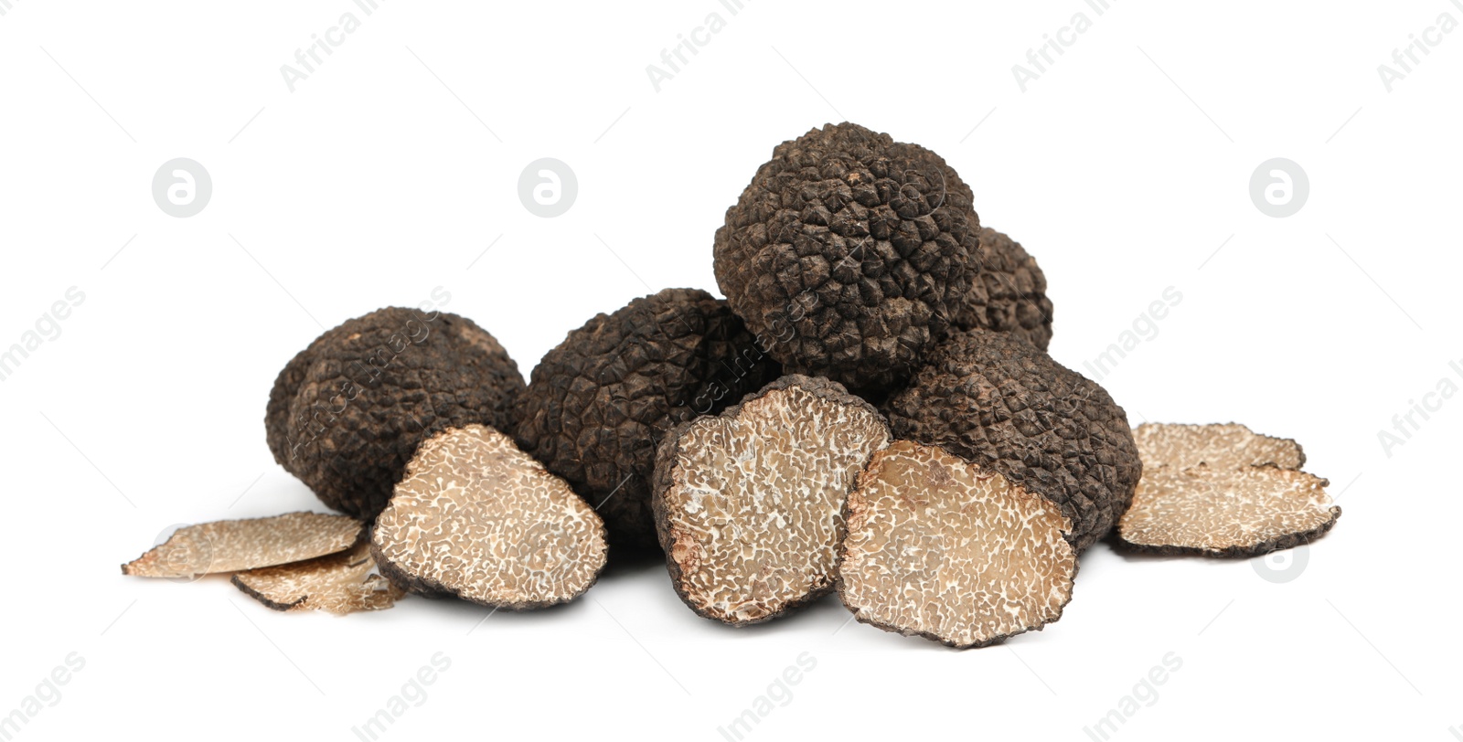 Photo of Cut and whole black truffles isolated on white