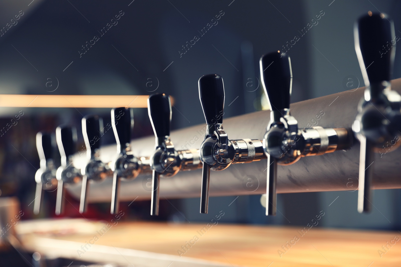 Photo of Row of shiny beer taps in pub