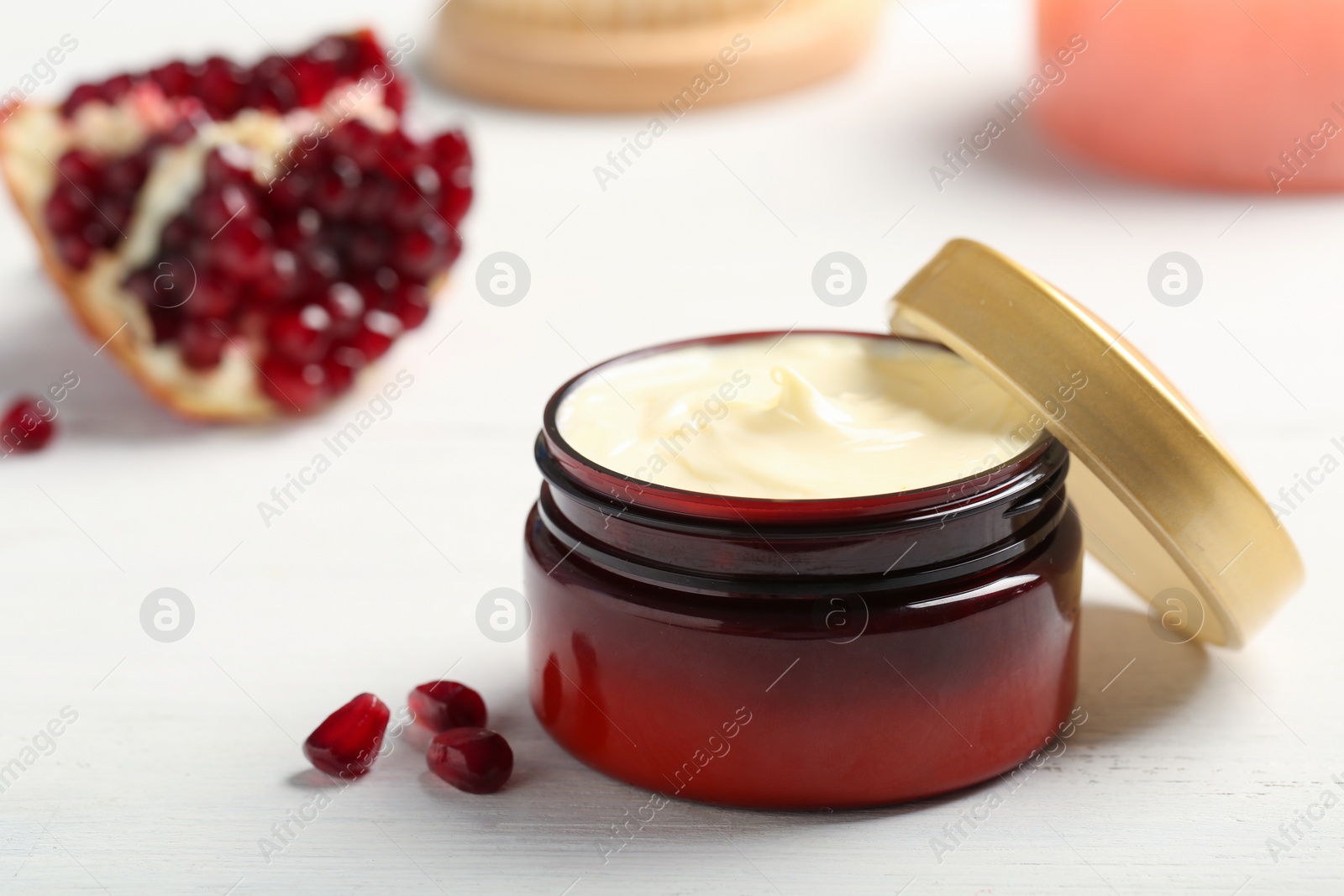 Photo of Closeup view of hand cream jar on wooden background