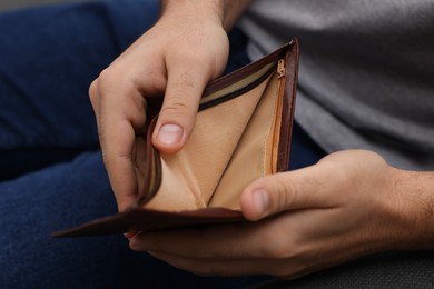 Photo of Closeup view of man with empty wallet
