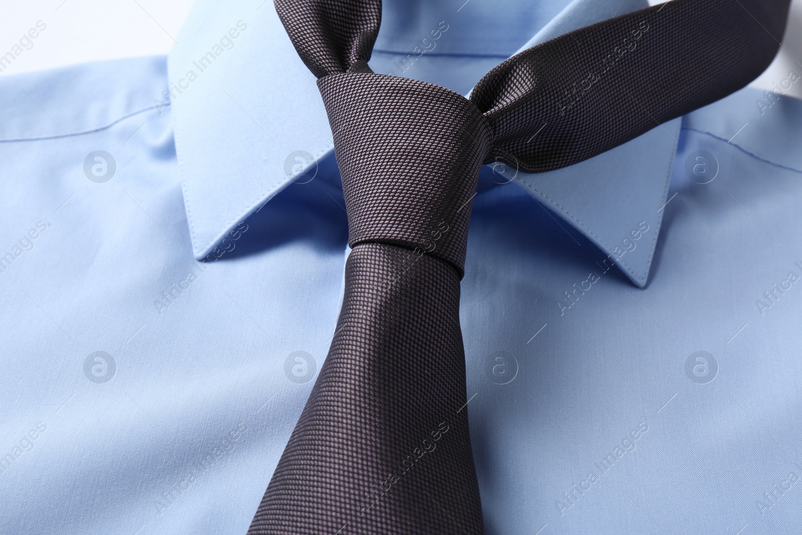 Photo of Color male necktie on blue shirt, closeup