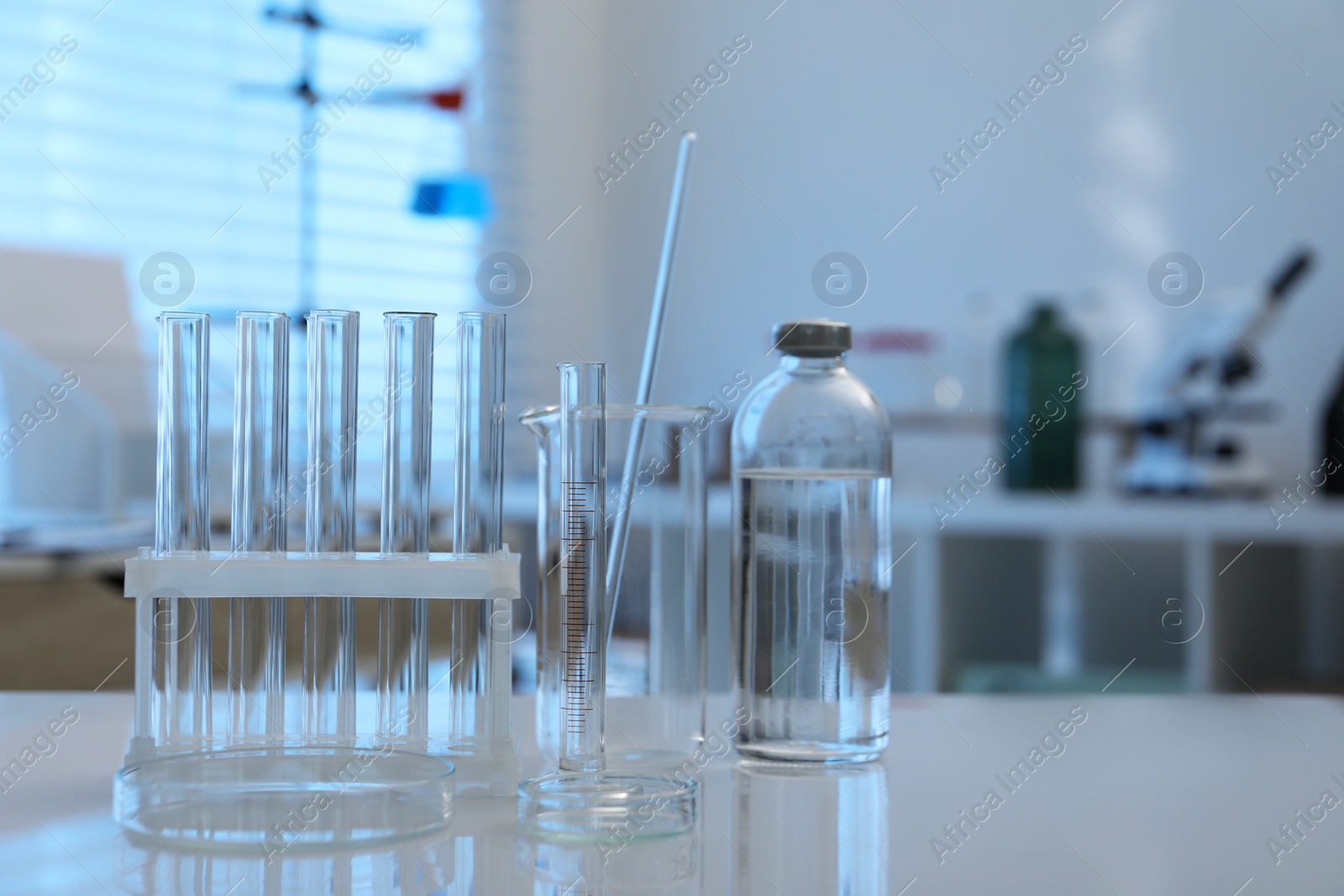 Photo of Laboratory analysis. Different glassware on white table indoors