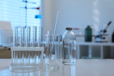 Photo of Laboratory analysis. Different glassware on white table indoors