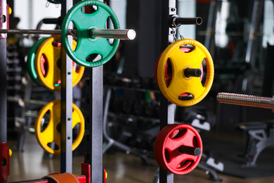 Photo of Barbell weight plates on rack in gym