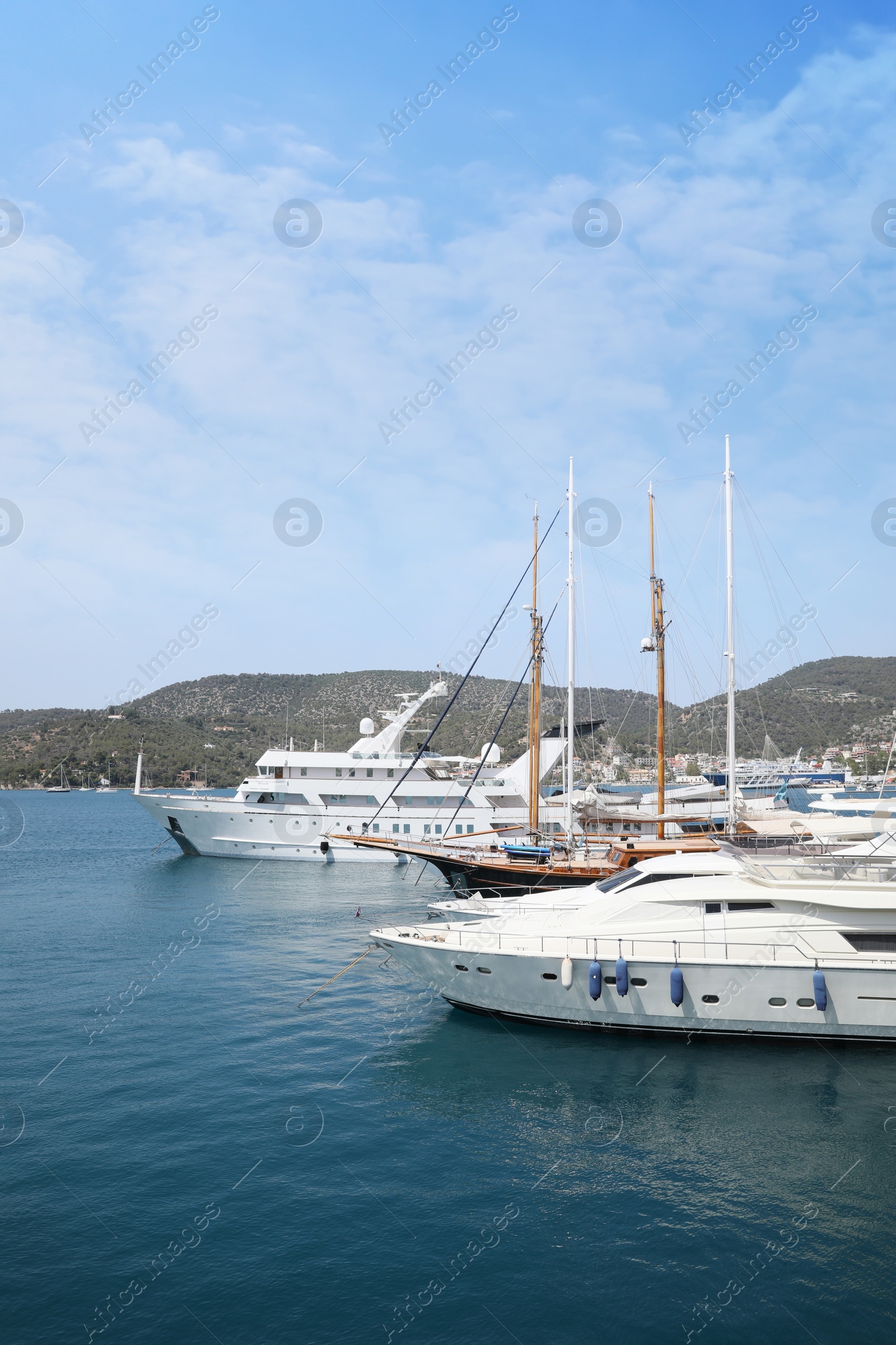 Photo of Beautiful view of different boats in sea near shore on sunny day