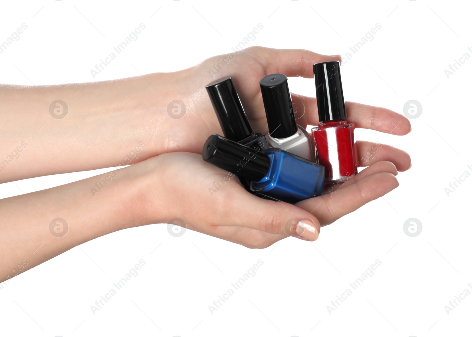 Photo of Woman holding nail polishes on white background, closeup