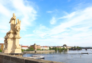 PRAGUE, CZECH REPUBLIC - APRIL 25, 2019: Cityscape with National Theatre from Charles Bridge on Vltava river