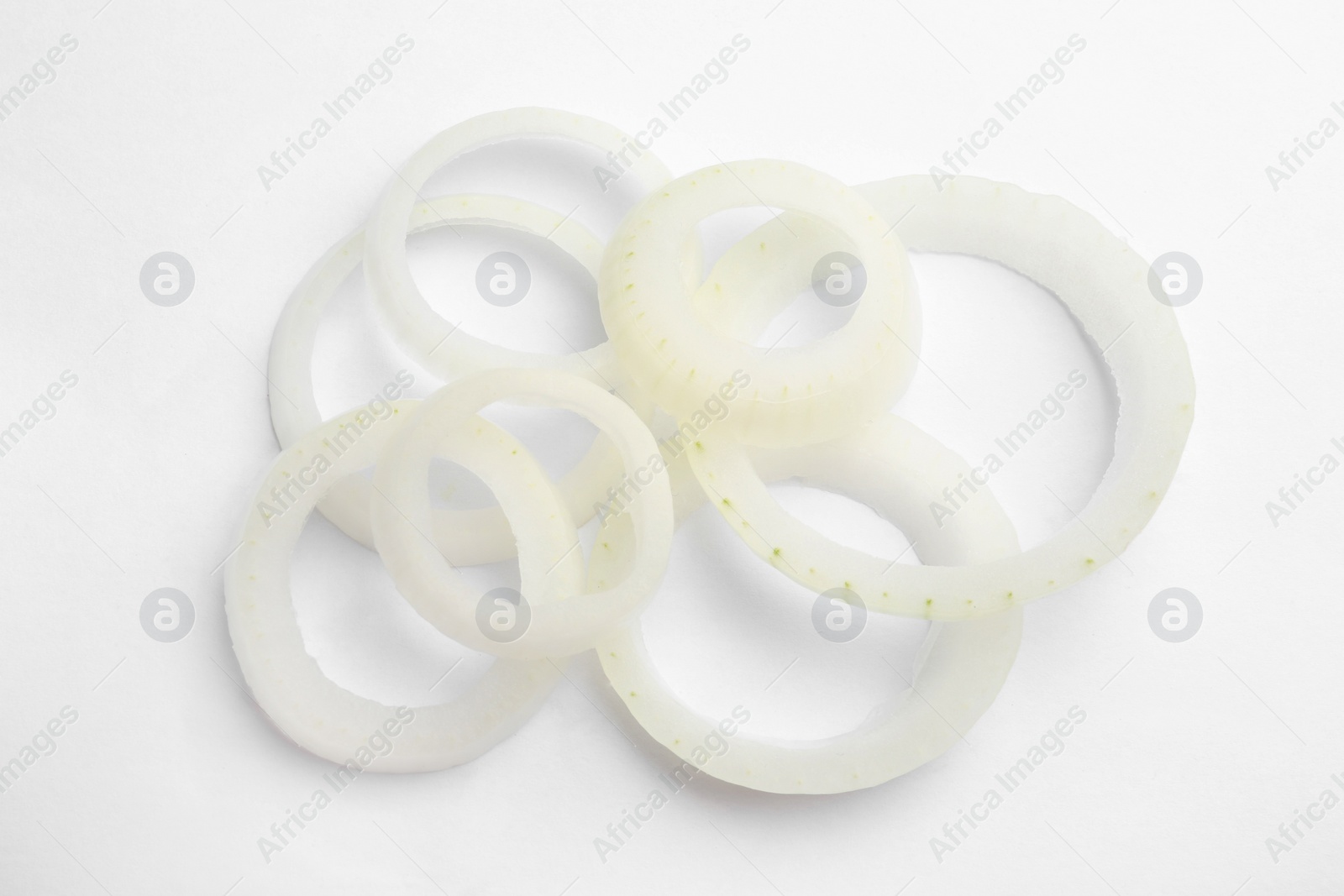 Photo of Fresh raw onion rings on white background