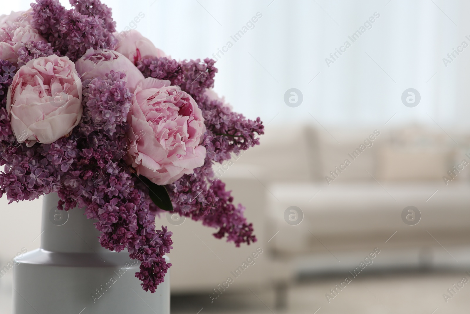 Photo of Beautiful bouquet of spring flowers in vase at home, closeup. Space for text