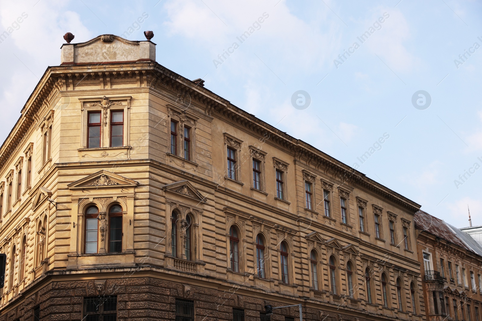 Photo of Beautiful old residential building against blue sky