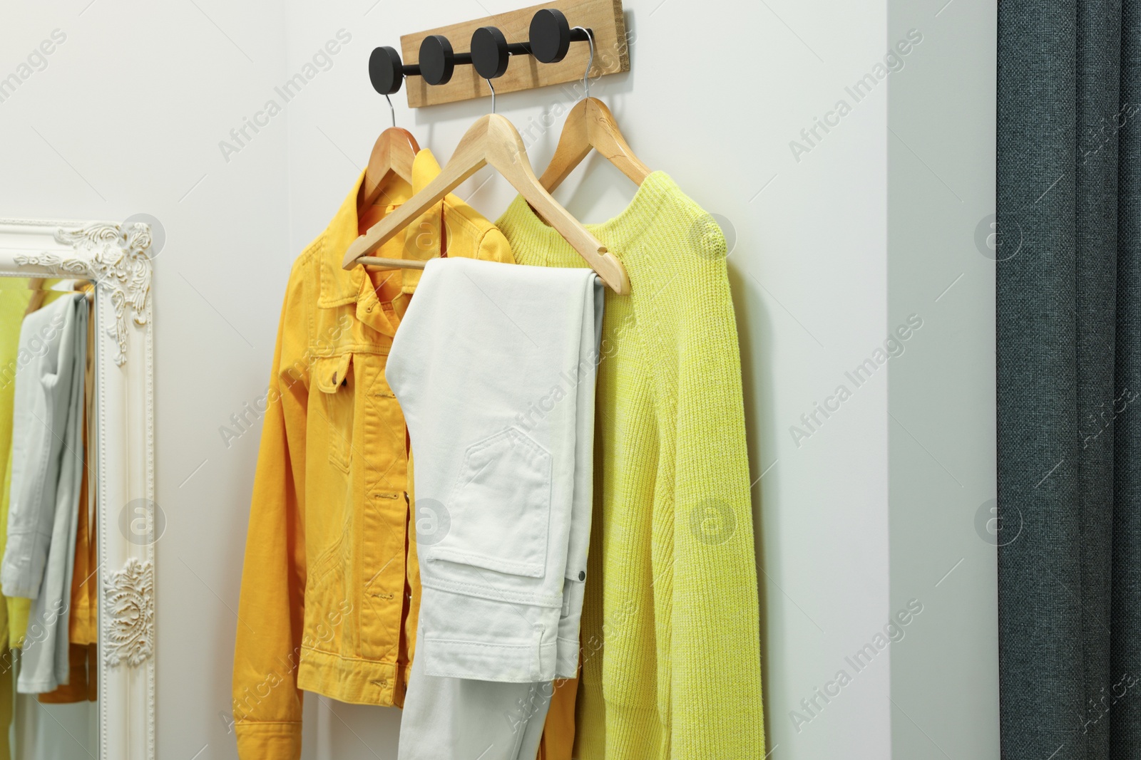 Photo of Stylish women's clothes on rack in dressing room