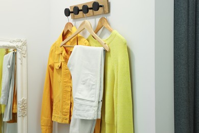 Photo of Stylish women's clothes on rack in dressing room