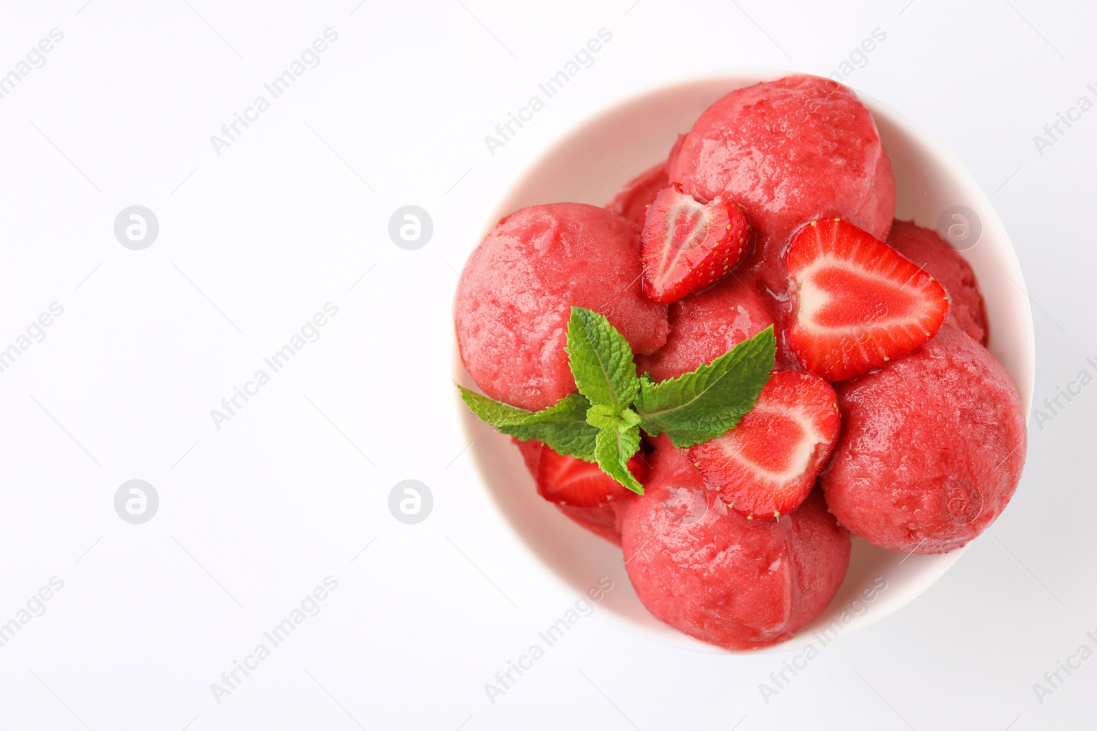 Photo of Delicious strawberry ice cream with mint and fresh berries in dessert bowl on white background, top view