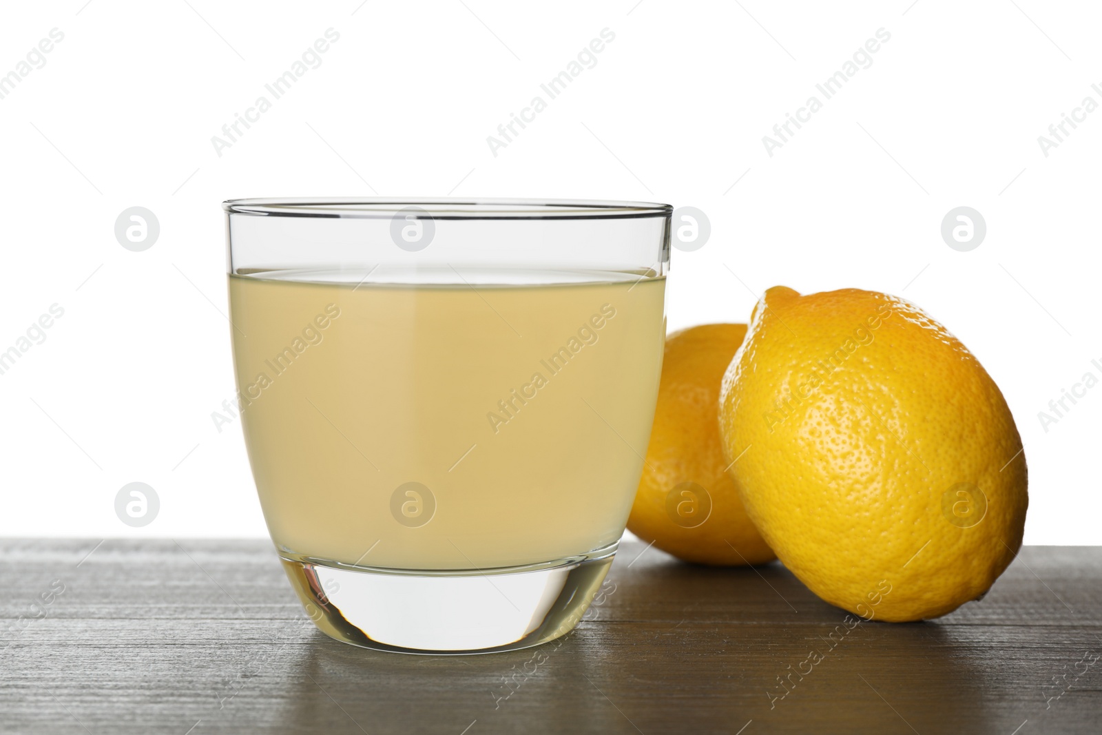 Photo of Delicious refreshing lemonade and fruits on wooden table against white background
