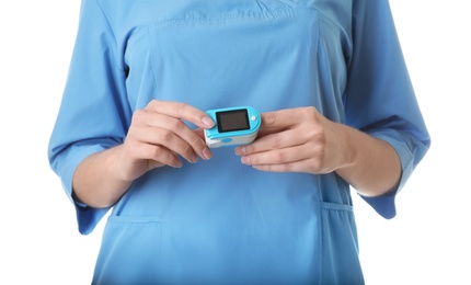 Female doctor using heart rate monitor on white background, closeup. Medical object