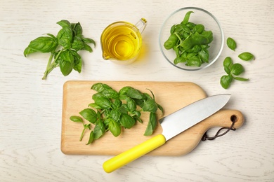 Flat lay composition with fresh basil leaves  on wooden background