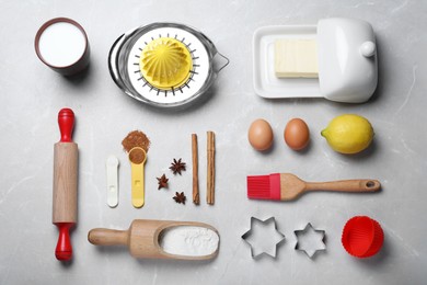 Photo of Cooking utensils and ingredients on light marble table, flat lay