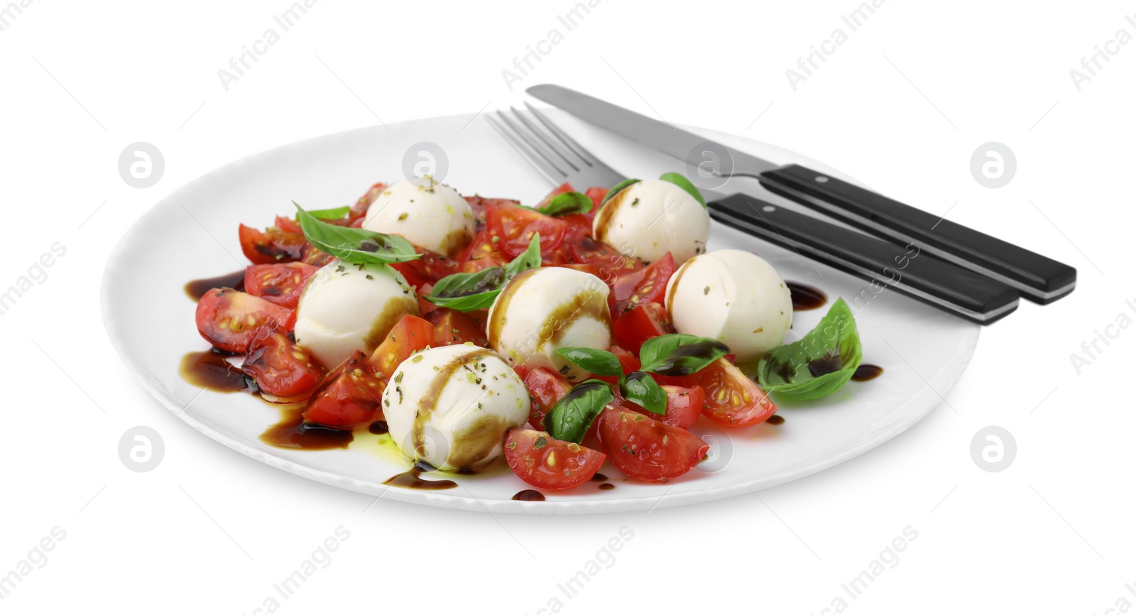 Photo of Tasty salad Caprese with tomatoes, mozzarella balls, basil and cutlery on white background