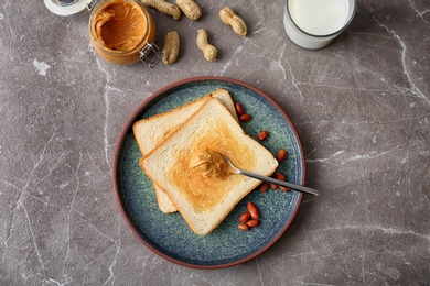 Flat lay composition with peanut butter and toasts on table