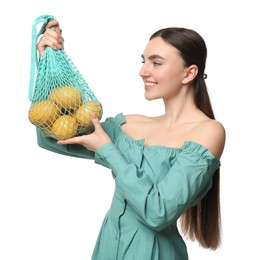 Photo of Woman with string bag of fresh lemons on white background