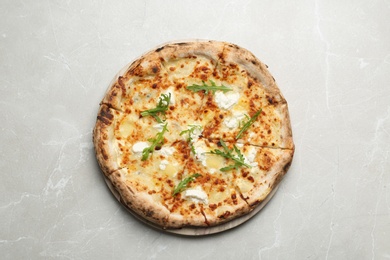 Image of Tasty cheese pizza on light marble table, top view