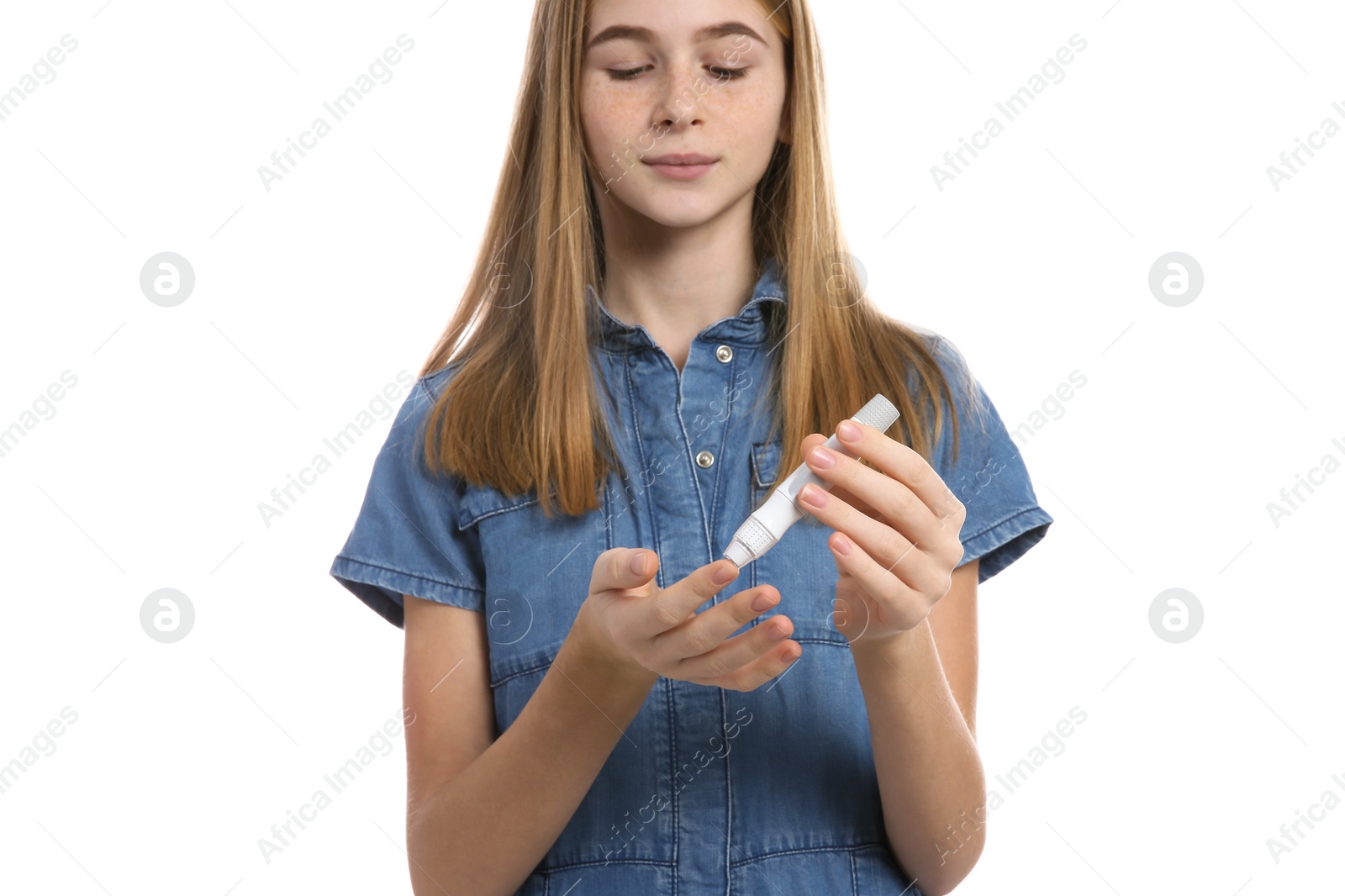 Photo of Teen girl using lancet pen on white background. Diabetes control