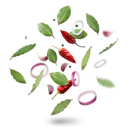 Image of Bay leaves, onion rings, garlic cloves, dry red and black peppers falling on white background
