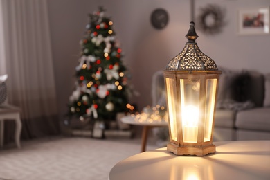 Beautiful decorative lantern and Christmas tree in room