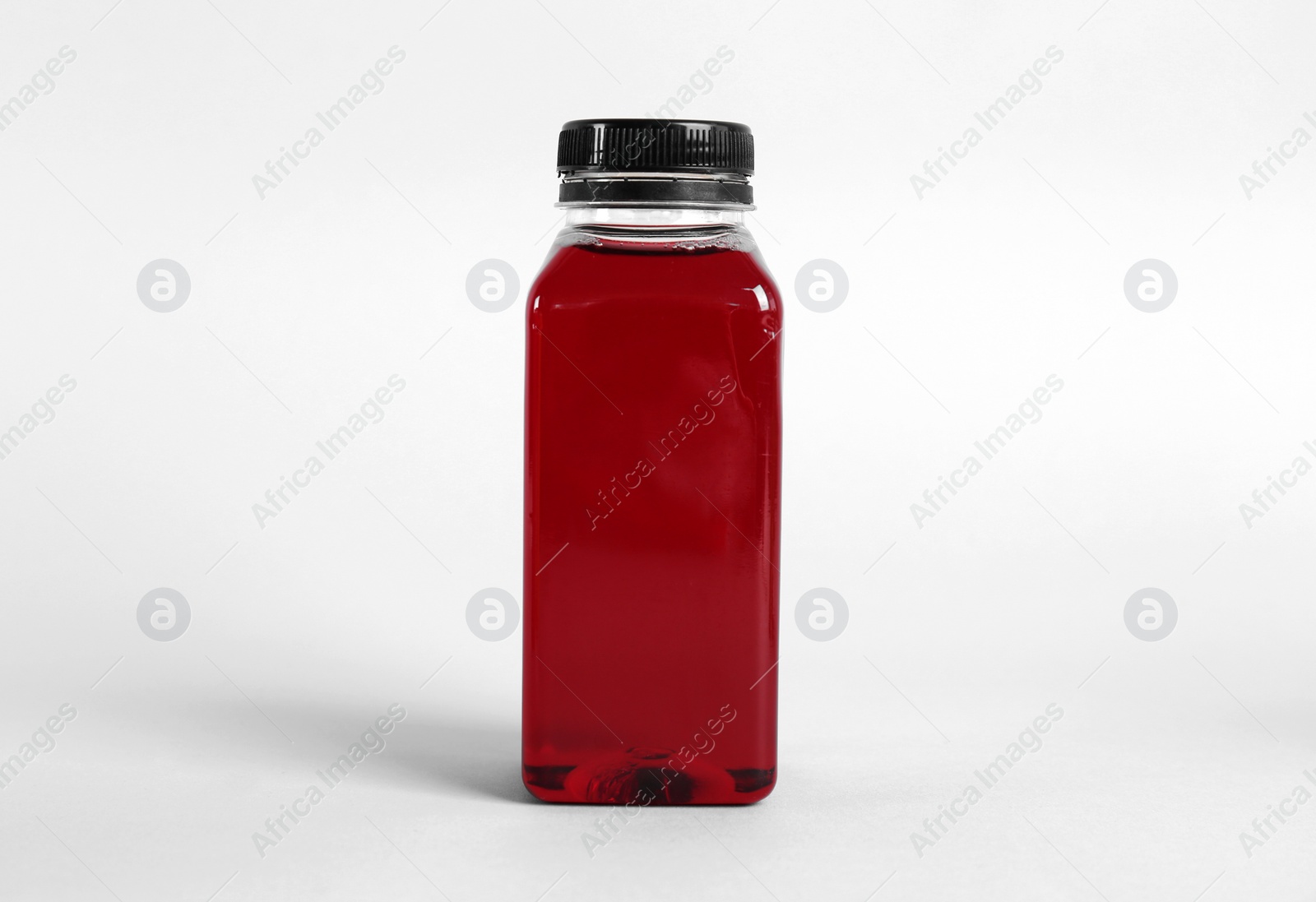 Photo of Bottle with delicious fresh juice on light background