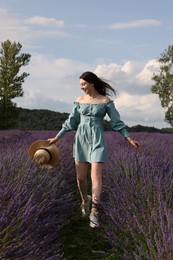 Photo of Smiling woman with hat in lavender field