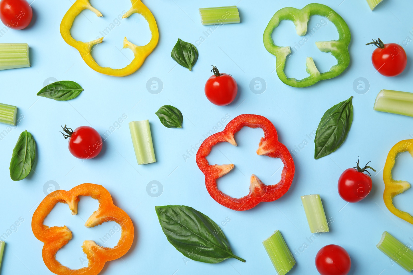 Photo of Flat lay composition with fresh ingredients for salad on light blue background