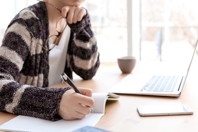 Photo of Young woman working at desk. Home office