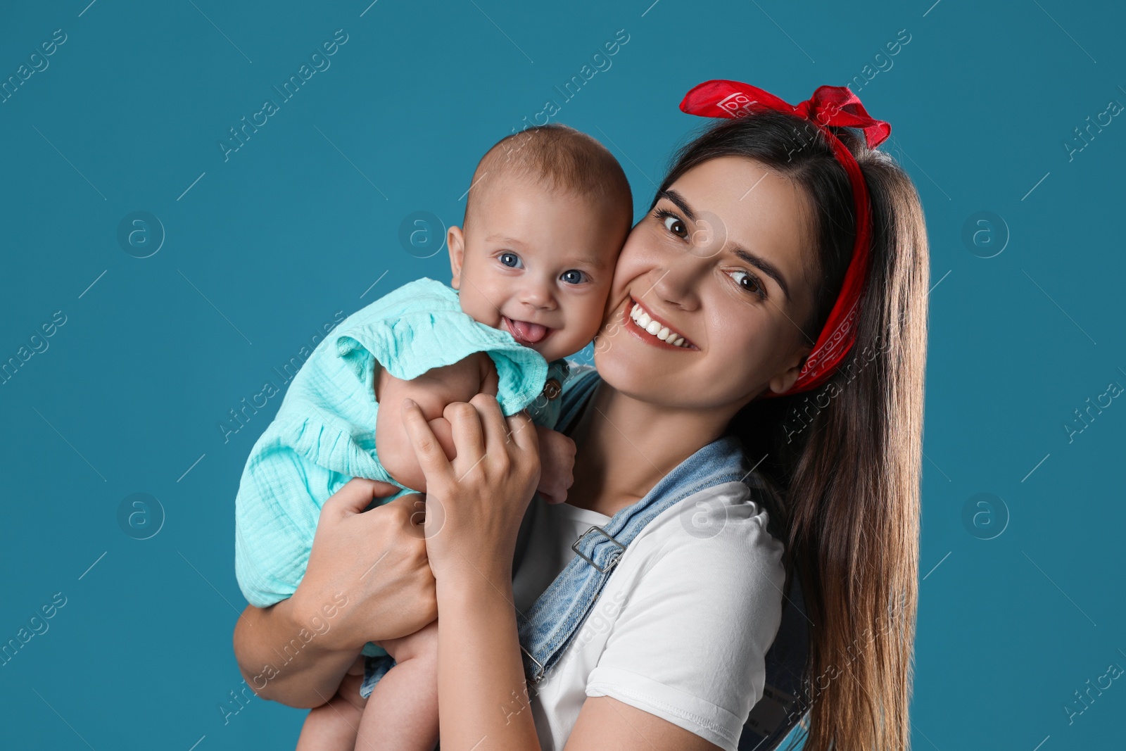 Photo of Beautiful mother with her cute baby on blue background