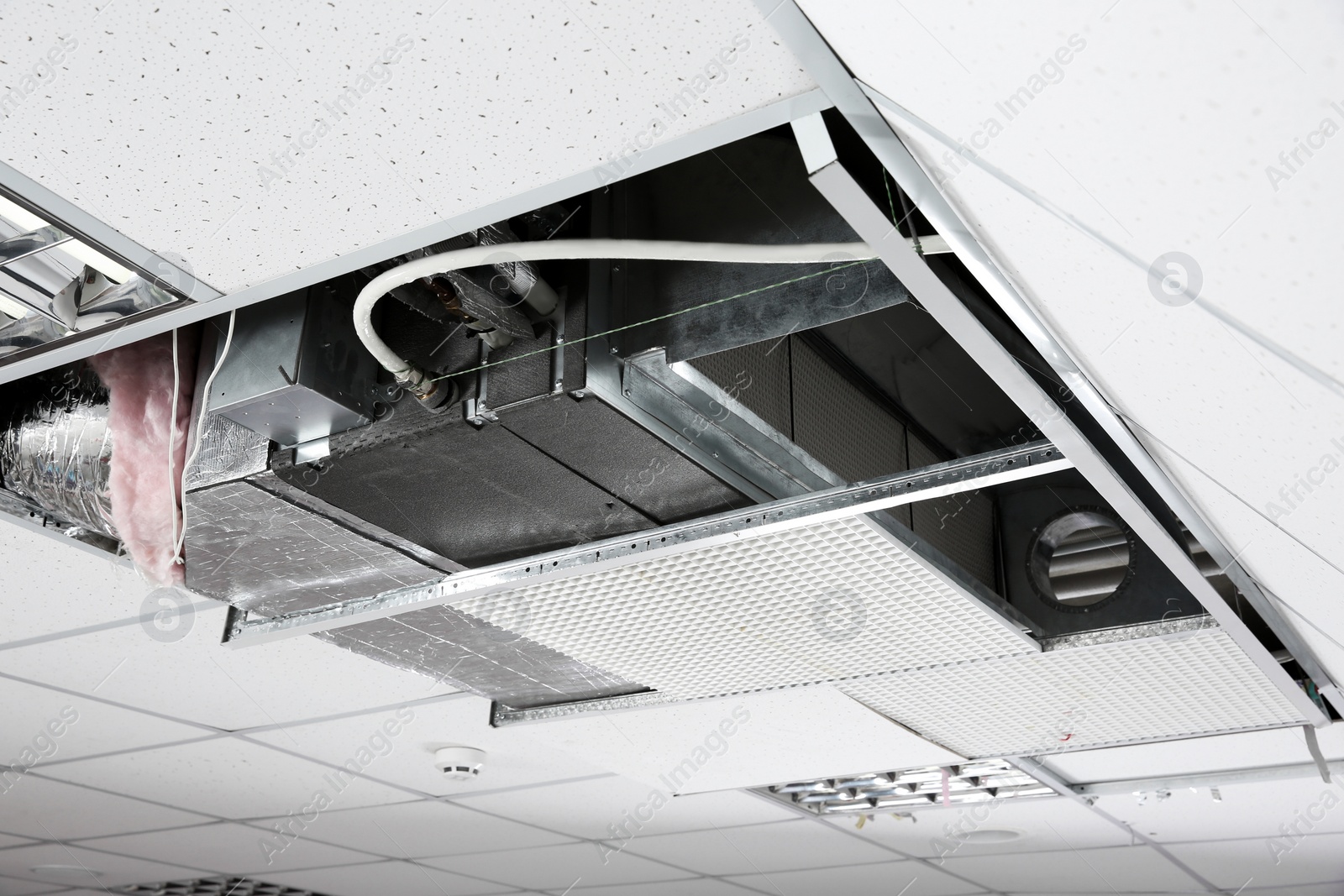 Photo of Modern air conditioner on ceiling indoors