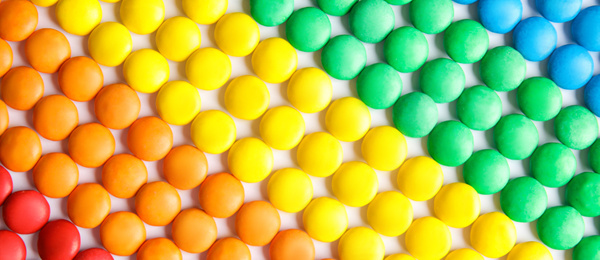 Image of Many colorful candies as background, top view. Banner design 