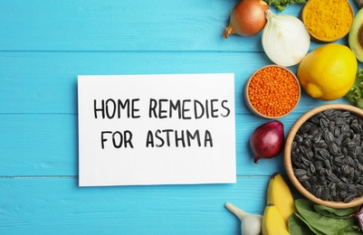 Photo of Natural products and note with text HOME REMEDIES FOR ASTHMA on wooden background, flat lay