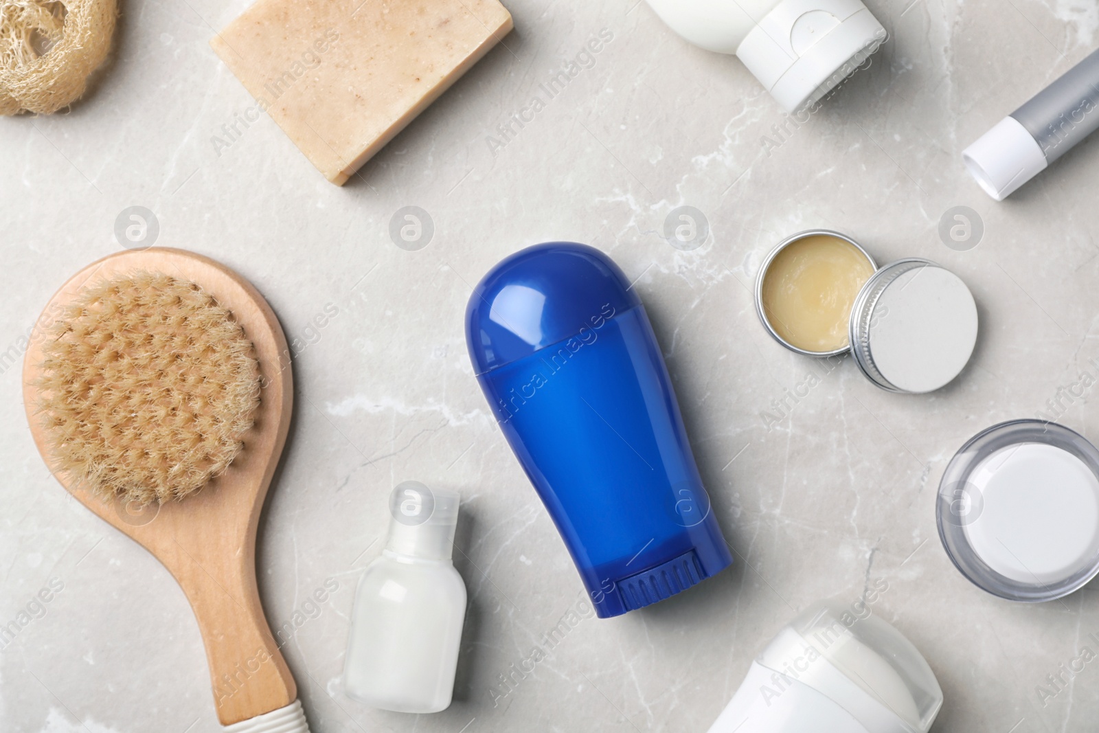 Photo of Flat lay composition with deodorant and toiletries on grey background