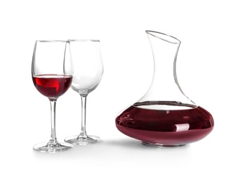 Elegant decanter with red wine and glasses on white background