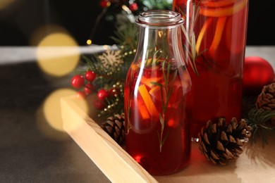 Photo of Aromatic punch drink and Christmas decor on table, closeup