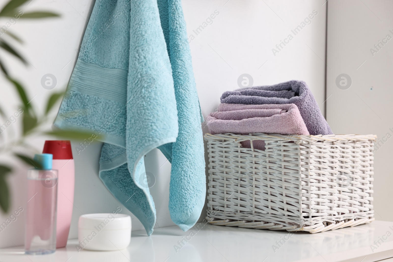 Photo of Fresh towels and toiletries on table indoors