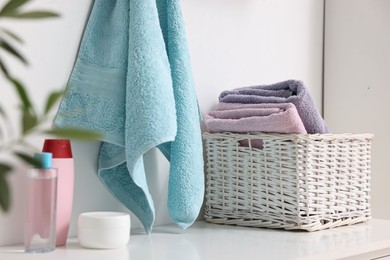 Photo of Fresh towels and toiletries on table indoors