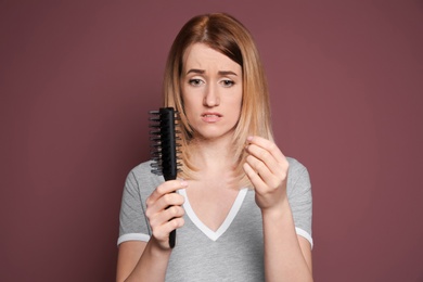 Photo of Young woman with hair loss problem on color background