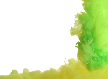 Photo of Splash of yellow and green inks on light background, closeup