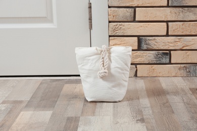 Photo of Stuffed bag near white door at home